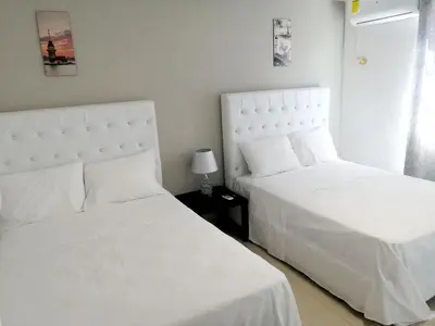 two beds sitting next to each other in a bedroom at Hotel Yamir in Santa Cruz de Barahona