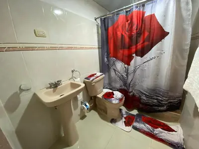 a bathroom with a sink and a toilet and a shower curtain at Santo Domingo Paradise V - #211 in La Estrella