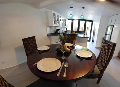 a wooden table with chairs and a dining room at Nanny Estates Cabarete kiters Condo C-6 in Cabarete