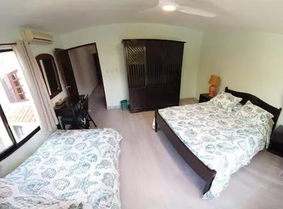 a bedroom with a bed and a couch in it at Nanny Estates Cabarete kiters Condo C-6 in Cabarete