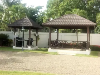 a gazebo with a roof on a yard at Luxury in the Caribbean in Sosúa