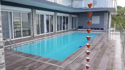 a swimming pool on a building with a house at Villa Laëti in Las Terrenas