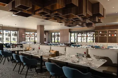 a restaurant with tables and chairs and a bar at Dreams Macao Beach Punta Cana - All Inclusive in Punta Cana