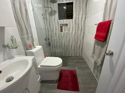 a bathroom with a white toilet and a sink at 6-1 SANTIAGO CITY GREAT COZY APT TO STAY - Cozy 3 bedrooms Apartment for 7 peoples - close to all kind the business wifi - Air Condition in Santiago de los Caballeros