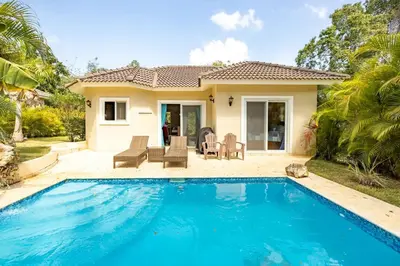 a villa with a swimming pool in front of a house at 2 Bed 2 Bath Villa with Jacuzzi, High Speed Wi-Fi in Sosúa