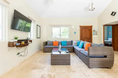 a living room with a couch and a tv at 2 Bed 2 Bath Villa with Jacuzzi, High Speed Wi-Fi in Sosúa