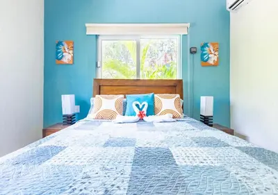 a bedroom with a large bed with blue walls at 2 Bed 2 Bath Villa with Jacuzzi, High Speed Wi-Fi in Sosúa