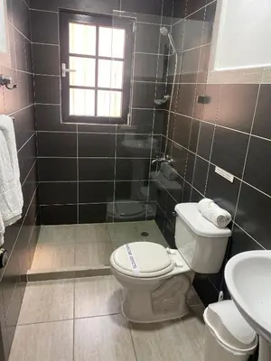 a bathroom with a toilet and a sink at Ocean Breeze Studios in Santo Domingo