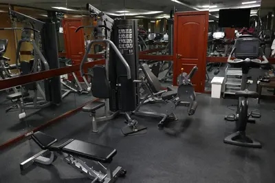 a gym with several treadmills and other equipment at Ramada by Wyndham Princess Santo Domingo in Santo Domingo