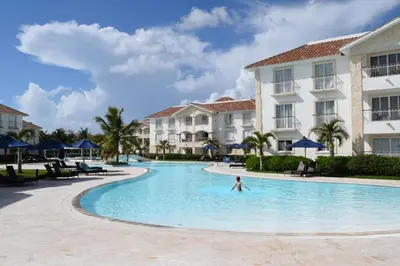 a person in a swimming pool at a resort at The blue lagoon of the Caribbean Sea. Velero 205.Cadaques Caribe in La Fragata