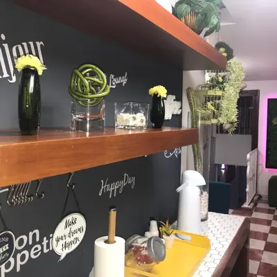 a kitchen with a yellow counter with vases on a shelf at Hotel Rey in Concepción de La Vega