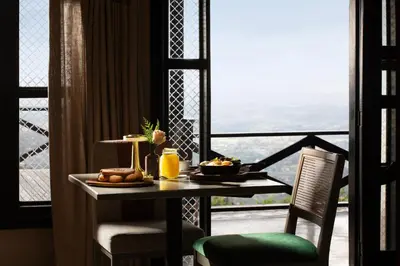 a table with food on it next to a window at Camp David Ranch in Santiago de los Caballeros