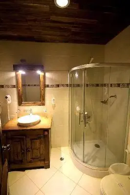 a bathroom with a shower and a sink at Matum Hotel & Casino in Santiago de los Caballeros