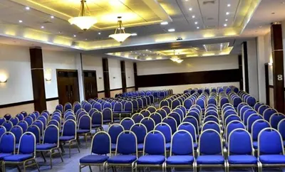 a room full of blue chairs in a hall at Matum Hotel & Casino in Santiago de los Caballeros