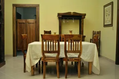 a dining room with a table with chairs and a mirror at Matum Hotel & Casino in Santiago de los Caballeros