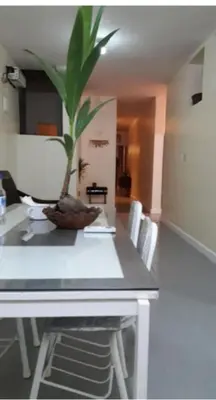 a table with a plant sitting on top of it at Recycled house in Santo Domingo