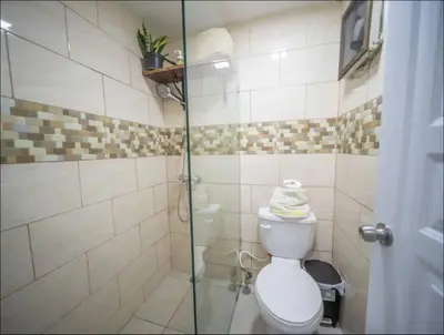 a bathroom with a toilet and a glass shower at 2 Guests 1bed Studio 3min To Beach And Main Street in Sosúa