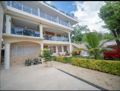 a large apartment building with a balcony at 2 Guests 1bed Studio 3min To Beach And Main Street in Sosúa