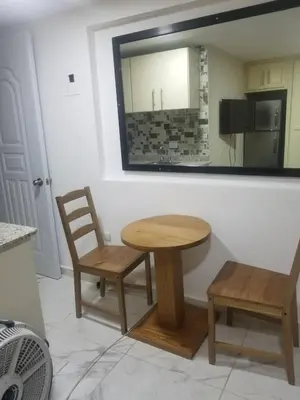 a table and chairs in a kitchen with a mirror at 2 Guests 1bed Studio 3min To Beach And Main Street in Sosúa