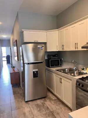 a kitchen with a stainless steel refrigerator and a sink at Casa Lambí in Cabrera