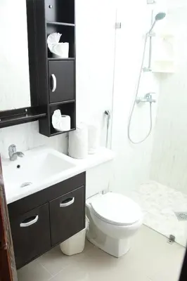 a bathroom with a toilet and a sink and a shower at Acuarium Suite Resort in Santo Domingo