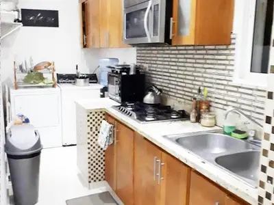 a kitchen with a sink and a stove top oven at Malecon Cozy Private Room 6 in Santo Domingo