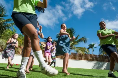 a group of people playing frisbee on the grass at Royalton Splash Punta Cana, An Autograph Collection All-Inclusive Resort & Casino in Punta Cana