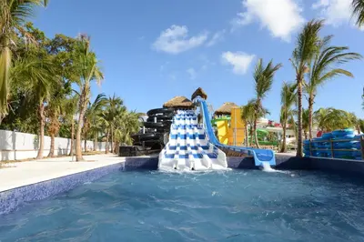 a water slide in a pool at a resort at Royalton Splash Punta Cana, An Autograph Collection All-Inclusive Resort & Casino in Punta Cana