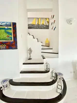 a staircase in a museum with art on the wall at Unique Luxury Pent House At Marina Casa De Campo in La Romana