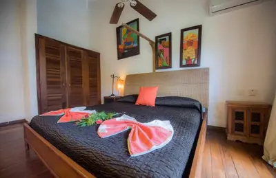 a bedroom with a bed with pillows on it at Penthouse Las Playas in Las Terrenas