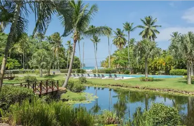 a resort with a pool and palm trees at Penthouse Las Playas in Las Terrenas