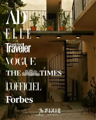 a magazine cover of a house with a spiral staircase at FIXIE LOFTS - Colonial Villa Suites with Pool in Santo Domingo