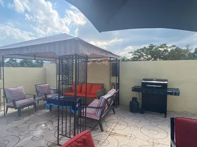 a gazebo with chairs and a piano on a patio at 2bedroom mountain view villa #2 in Muñoz