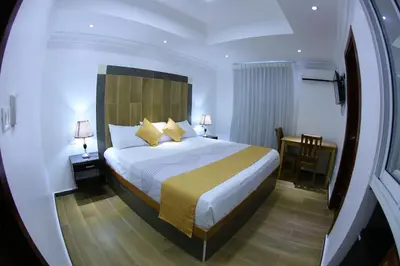 a hotel room with a bed and a table at Hotel Vicentina in Boca Chica