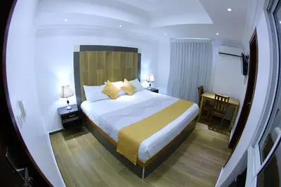a hotel room with a bed and a desk at Hotel Vicentina in Boca Chica