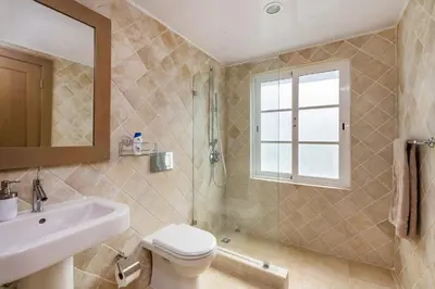 a bathroom with a toilet and a sink and a shower at Luxury & Modern Villa with Pool at Cocotal Golf & Country Club in Punta Cana