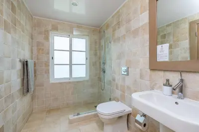 a bathroom with a toilet and a sink at Luxury & Modern Villa with Pool at Cocotal Golf & Country Club in Punta Cana