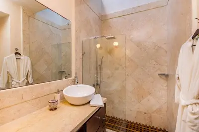 a bathroom with a sink and a shower at Unique Villa with Ocean and River Views - Staff & Golf Carts in La Romana