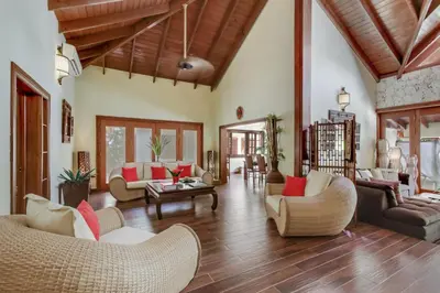 a living room with couches and a table at Beautiful Villa with Pool, Gym & Maid in Punta Cana