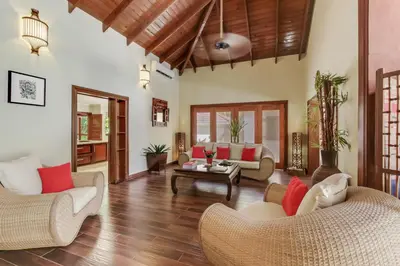 a living room with couches and a table at Beautiful Villa with Pool, Gym & Maid in Punta Cana