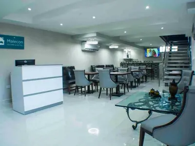 a dining room with tables and chairs in a restaurant at Malecon Cozy - Premium Plus 5 in Santo Domingo