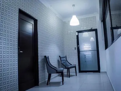 a waiting room with two chairs and a door at Malecon Cozy - Premium Plus 5 in Santo Domingo