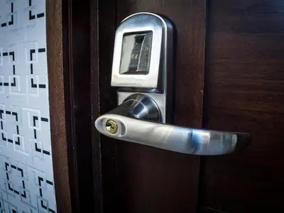 a cell phone sticking out of a wooden door at Malecon Cozy - Premium Plus 10 in Santo Domingo