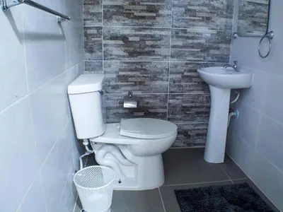 a bathroom with a toilet and a sink at Malecon Cozy - Premium Plus 10 in Santo Domingo