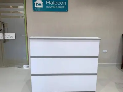 a white dresser in a room with a sign at Malecon Cozy - Premium Plus 16 in Santo Domingo