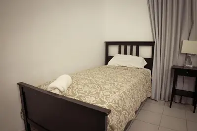 a bedroom with a bed with a bedspread and pillows at Residenciales H1 & H2 - Breakfast & Room Service - Airport close in Santiago de los Caballeros
