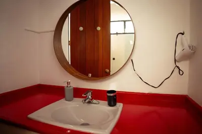 a bathroom with a sink and a mirror at Residenciales H1 & H2 - Breakfast & Room Service - Airport close in Santiago de los Caballeros