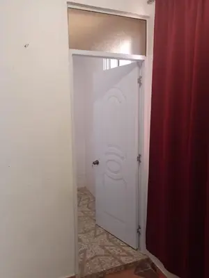 a white door in a room with a red curtain at Caribean House in Boca Chica