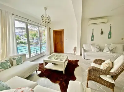 a living room with a couch and a table at Beautiful Apt Dominicus Bayahibe, Walk To Beach! in La Laguna