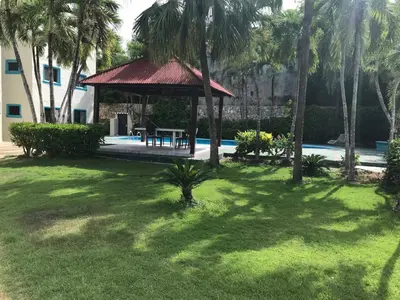a gazebo with a table in a yard at La Gaviota A3 in Juan Dolio